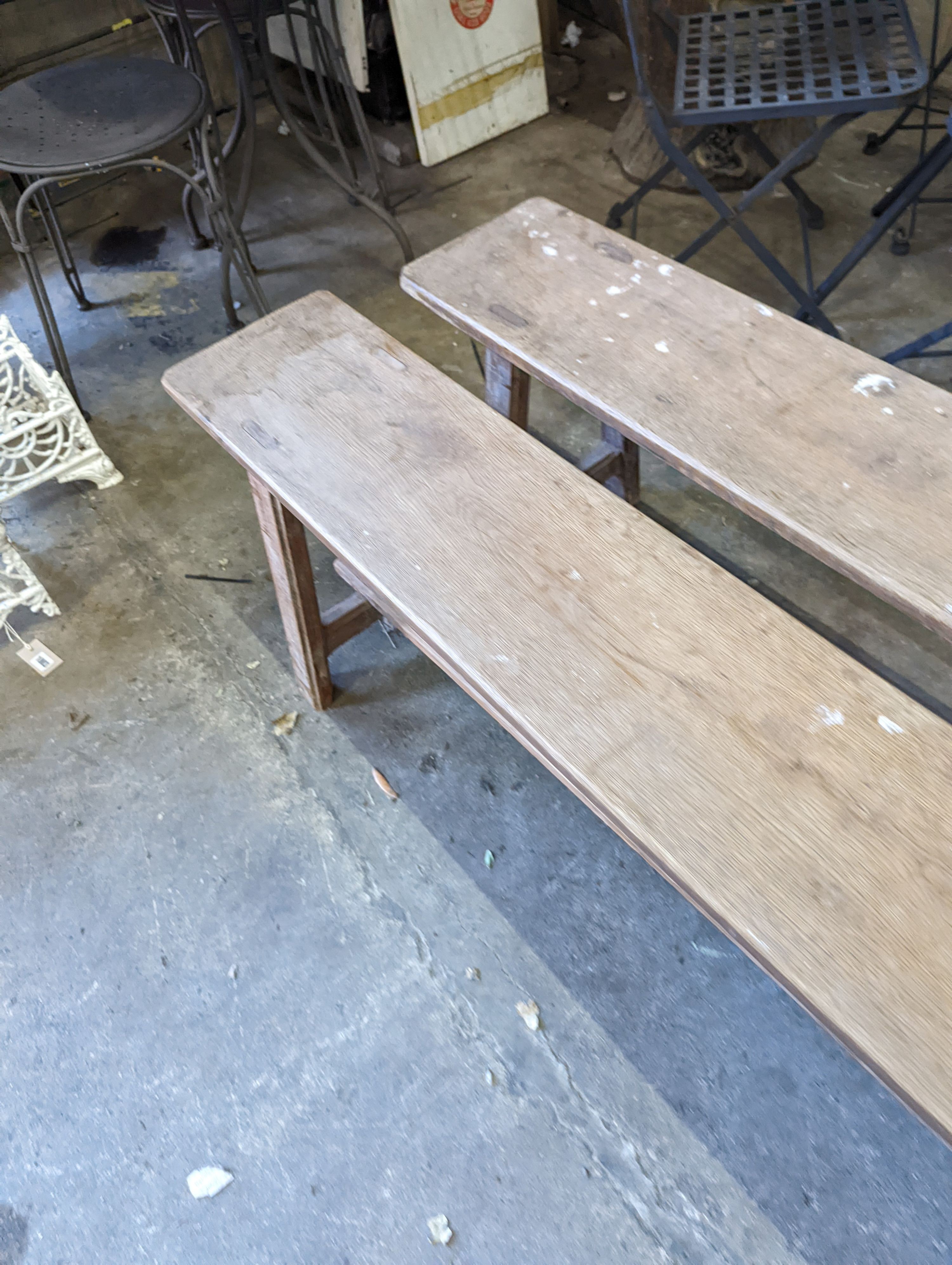 A pair of 19th century French provincial oak long bench seats, length 300cm, depth 24cm, height 45cm
